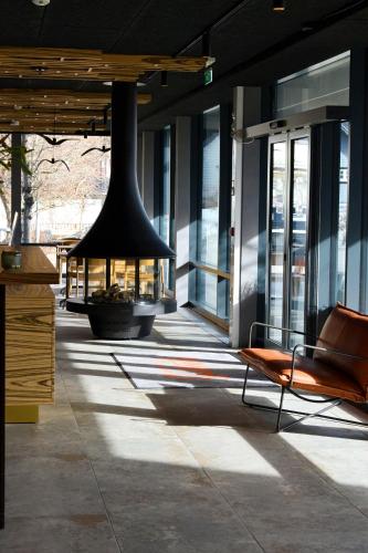 a building with a black bell hanging from the ceiling at Andenes Suitehotel in Andenes