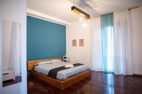 a bedroom with a bed with a blue wall at Casa _ Cuco in Loreto