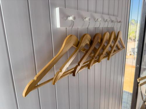 a bunch of wooden utensils hanging on a wall at Hill River Nature Reserve in Jurien Bay