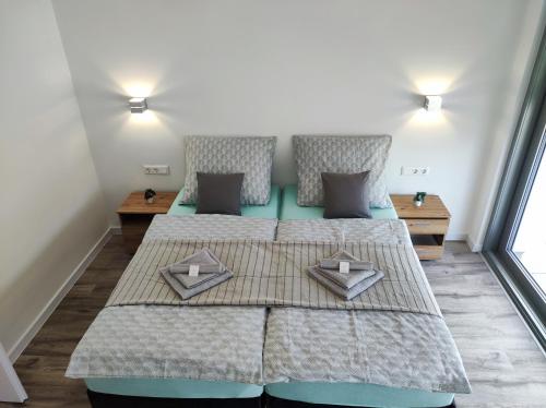 a bedroom with two beds with pillows on them at Balatonkenese Sunshine Villa in Balatonkenese