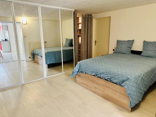 a bedroom with a bed and a mirror at maison in Cholet