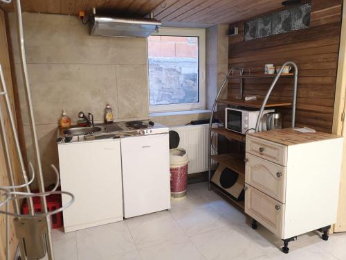 a small kitchen with a sink and a microwave at Apartment /flat in Schwebheim