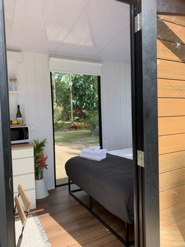 una camera con un letto in una stanza con una finestra di Piyar Tiny Haven a Julatten