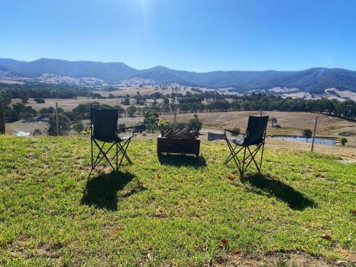 two chairs sitting on top of a grassy field at Nichol Road Hideaway at Annies Retreat by Tiny Away in Yackandandah