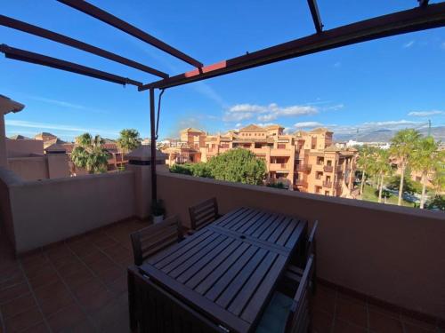 a balcony with a bench and a view of buildings at Albatros Apartamentos Playa Granada in Motril