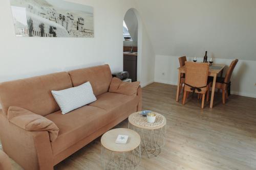 a living room with a couch and a table at Gästehaus Bröcker Wohnung 7 in Büsum