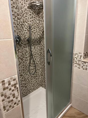 a shower with a glass door in a bathroom at La Marinella in Palmi