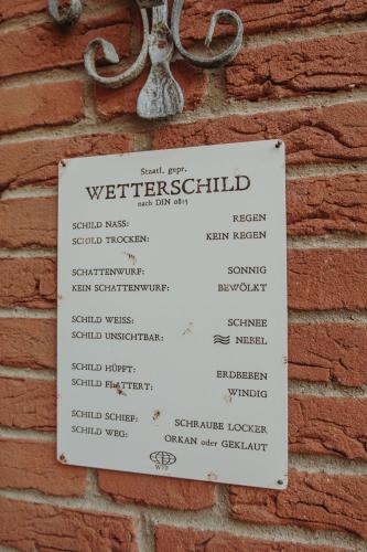 a sign on the side of a brick wall at Gästehaus Bröcker Wohnung 8 in Büsum