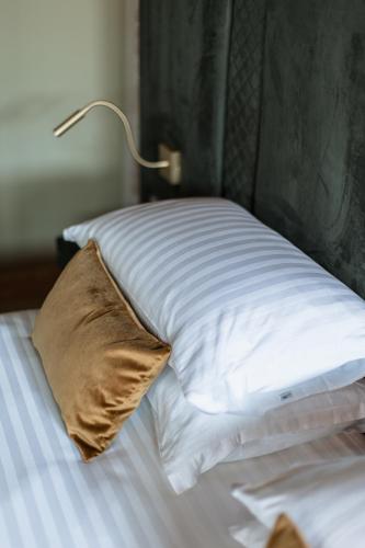 a bed with a pillow and a lamp on it at Pavillon Suite in Peschiera del Garda