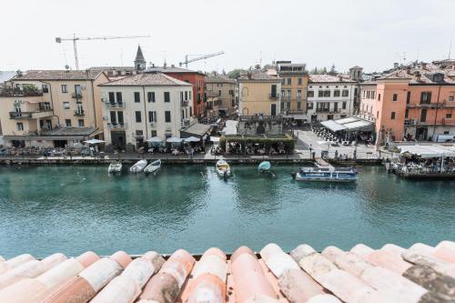 a view of a river with boats in a city at Pavillon Suite in Peschiera del Garda