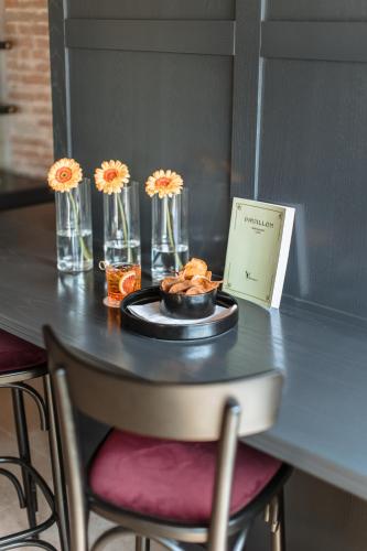 a table with a plate of food and flowers on it at Pavillon Suite in Peschiera del Garda
