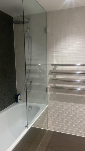 a bathroom with a shower and a bath tub at Luxury stay near O2 and canary wharf in London