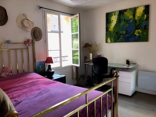 une chambre avec un lit, un bureau et une fenêtre dans l'établissement Maison de ville avec jardin centre Montfort l'Amaury, à Montfort-lʼAmaury