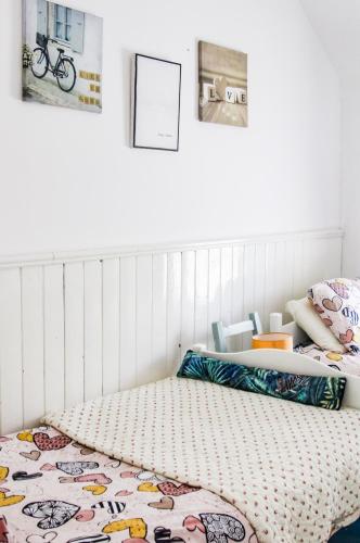 a bedroom with a bed and some pictures on the wall at Boss’s farmhouse in Valentia Island