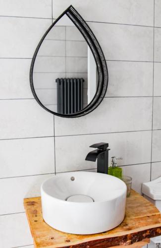 a bathroom with a white sink and a mirror at Boss’s farmhouse in Valentia Island
