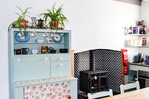 a kitchen with a blue cabinet with a stove at Boss’s farmhouse in Valentia Island