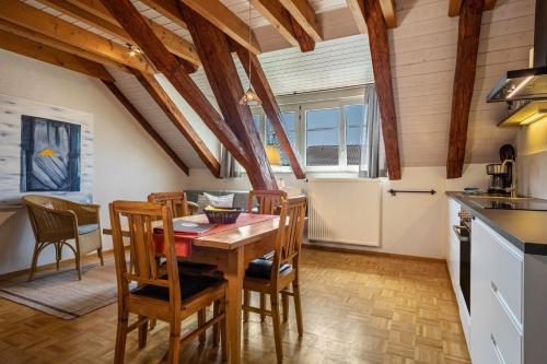 a kitchen and dining room with a wooden table and chairs at Obst- Ferienhof Ragg in Immenstaad am Bodensee