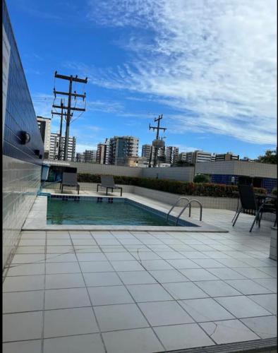 a swimming pool on the roof of a building at Apartamento próximo a praia in Maceió