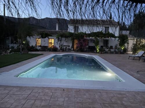 a swimming pool in front of a house at La Vista Huma in Alora