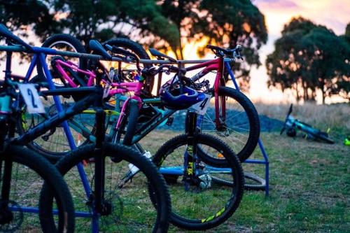 a group of bikes parked on a rack in the grass at Snowy Valleys iconic stay - Moonshiner Cottage @ Distillery in Tumbarumba
