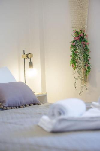 a bedroom with a bed with a plant hanging from the wall at Over the Messinian Plain in Kalamata