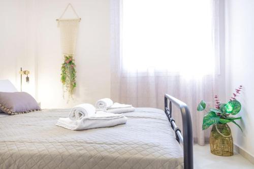 a bedroom with a bed with towels on it at Over the Messinian Plain in Kalamata