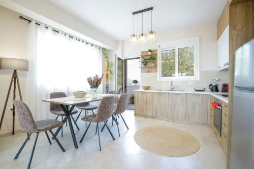 a kitchen and dining room with a table and chairs at Over the Messinian Plain in Kalamata