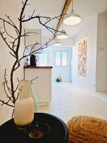 a vase sitting on a table in a room at Casa Digo - Bright & Stylish in Lagos