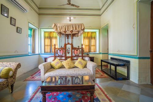 a living room with a couch and a table at Koolwal Kothi Zinc Journey by The Fern, Nawalgarh, Rajasthan in Nawalgarh