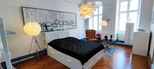 a bedroom with a bed and a chair in a room at Designwohnung am Schloss in Weilburg