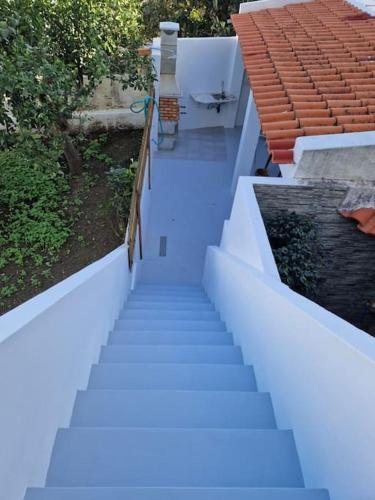 a staircase leading up to a house with blue paint at Casa Digo - Bright & Stylish in Lagos