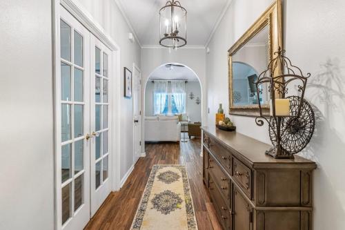 a hallway with a dresser and a mirror and a bathroom at Southern Charm in Foley