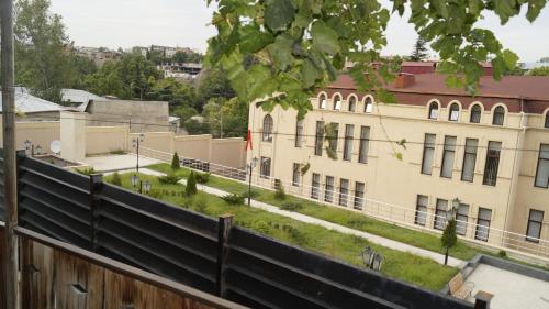 a building with a yard in front of a building at Nino's Guest House in Tbilisi City