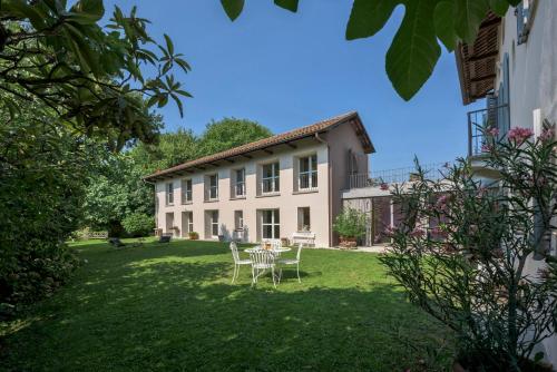 a house with a table and chairs in the yard at Villa Zeta / Design Villa with Private Pool in Canelli