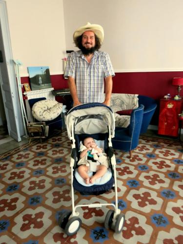a man standing with a baby in a stroller at Maison Decò in Catania