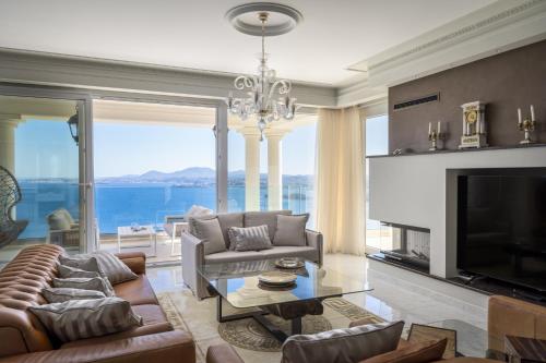 a living room with a view of the ocean at Villa Monte Leone by Konnect with Pool, Hot Tub, Spa Room & Stunning Seaview in Pyrgi