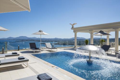 a pool with a gazebo and a swimming pool at Villa Monte Leone by Konnect with Pool, Hot Tub, Spa Room & Stunning Seaview in Pyrgi