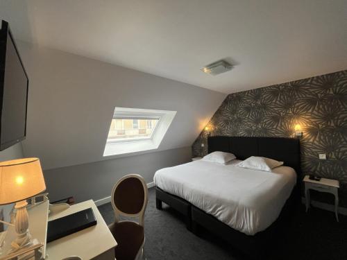 a hotel room with a bed and a window at Saint Jean in Wimereux