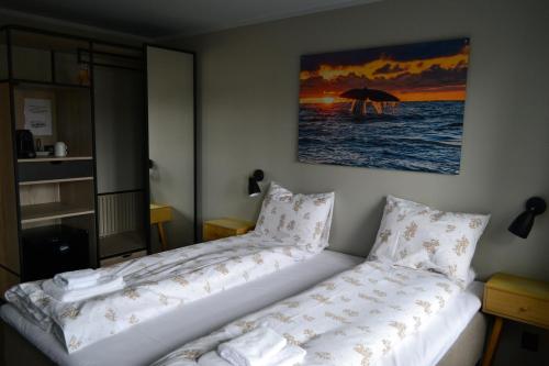 a hotel room with a bed with an umbrella at Andenes Suitehotel in Andenes