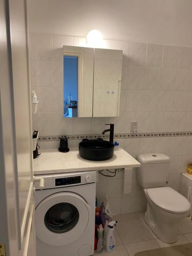 a bathroom with a washing machine and a toilet at Newly renovated- Regina Gardens 1, Venus Beach 500 m, Sea&Sunsets view, license oo12075 in Paphos