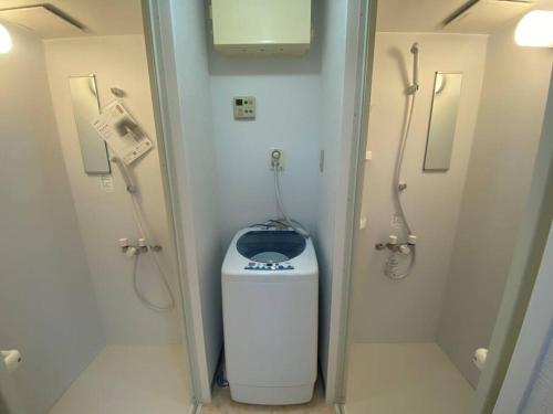 a bathroom with a shower and a trash can at tokyo Large family vacation rentals in Tokyo