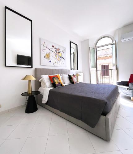 a bedroom with a large bed and a tv at Trevi over the top apartment in Rome