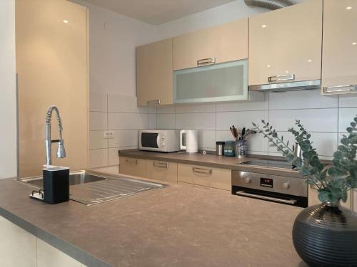 a kitchen with a sink and a microwave at Central City Nest - Sandra&David in Zadar