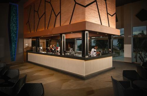 a restaurant with a counter with people preparing food at Riu Montego Bay - Adults Only - All Inclusive in Montego Bay