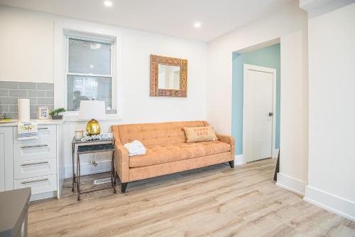 a living room with a couch and a table at Cozy Private Apartment - 3 minutes from Downtown with free parking in Ottawa