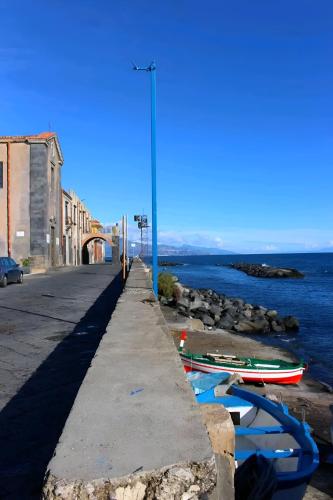 a sidewalk with boats on it next to the water at Casa Vacanze Etna Sunset in Giarre