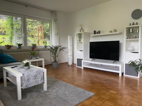 a living room with a flat screen tv on a wall at Auf dem Kleeberg in Niederzissen