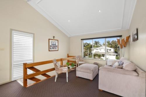 a living room with a couch and a chair at Perfect Beach getaway in Narrabeen