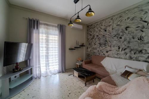 a living room with a couch and a tv at Apartment near Piraeus’ port in Piraeus