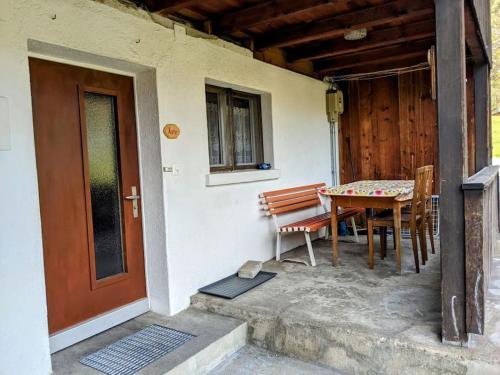 a porch with a table and chairs next to a door at Alpine chalet apt w/parking and porch in Meiringen